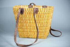 Conical wicker basket with lang leather handles